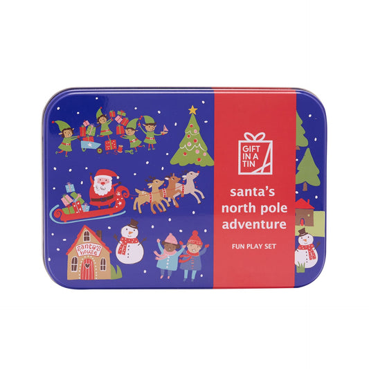 A rectangular metal tin with rounded corners featuring a Christmas-themed illustration and text that reads ' santa's north pole adventure' and 'FUN PLAY SET.' The tin has a dark blue background with festive scenes including Santa in a sleigh, elves, a Christmas tree, snowman, house, and children, plus a red vertical panel on the right with a gift icon and brand text.
