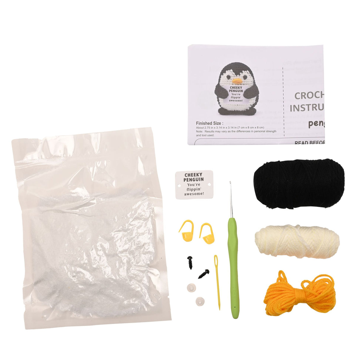 Crochet kit laid out on a white background, including a clear plastic bag, crochet instruction card with a penguin illustration, black yarn, cream yarn, orange yarn, a green-handled hook, small yellow earplugs, black and white loops, and a small card reading Cheeky Penguin.