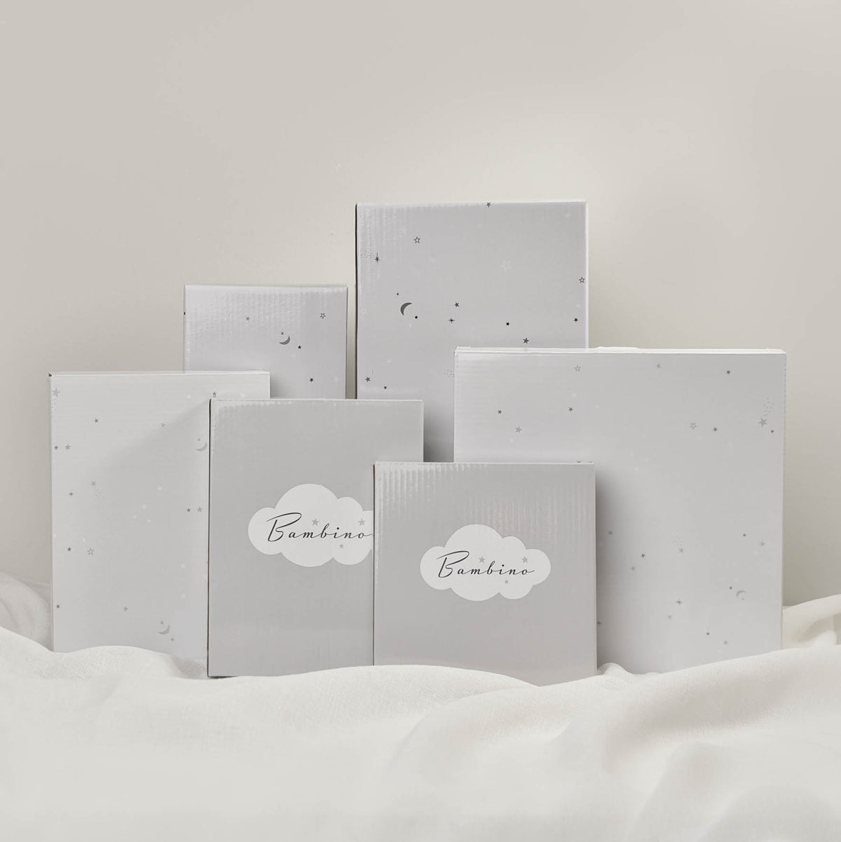 Set of gray gift boxes with 'Bambino' text on a light background
