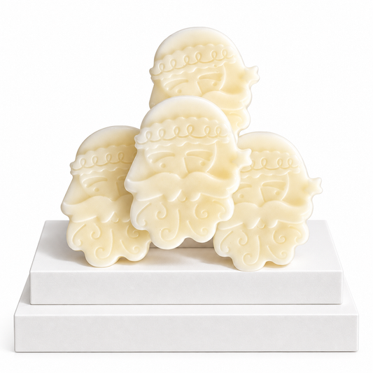 Four cream-colored, Santa Claus-shaped sWax Melts arranged on a two-tiered white display block against a white background.