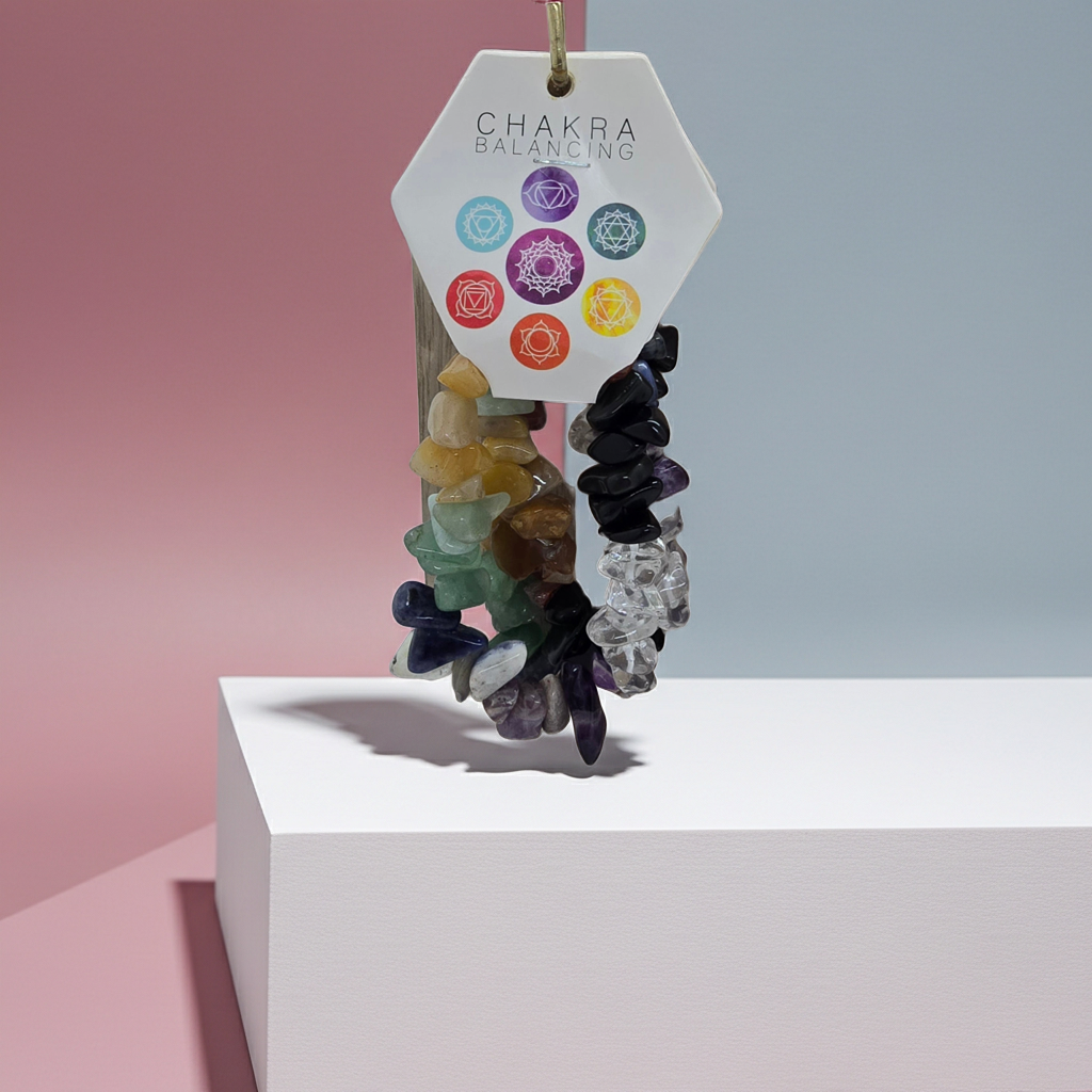 Colourful Energy stone bracelet on a stand with a 'Chakra Balancing' tag against a gradient background