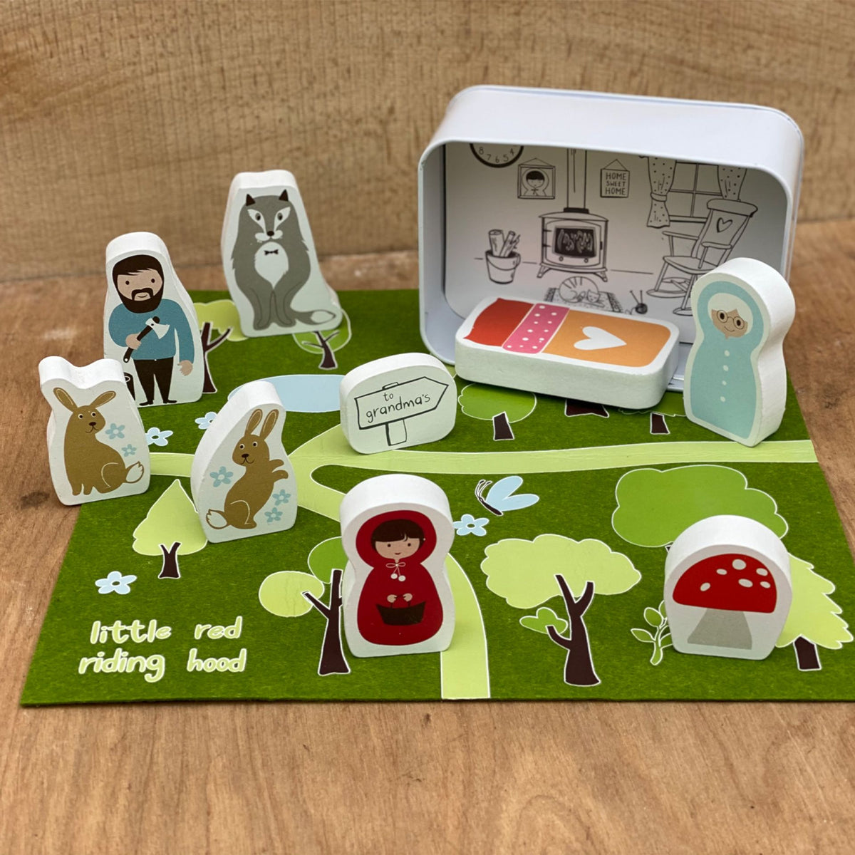 Storybook scene with character figures on a wooden surface