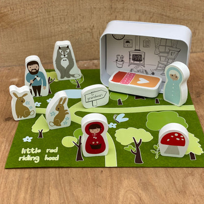 Storybook scene with character figures on a wooden surface