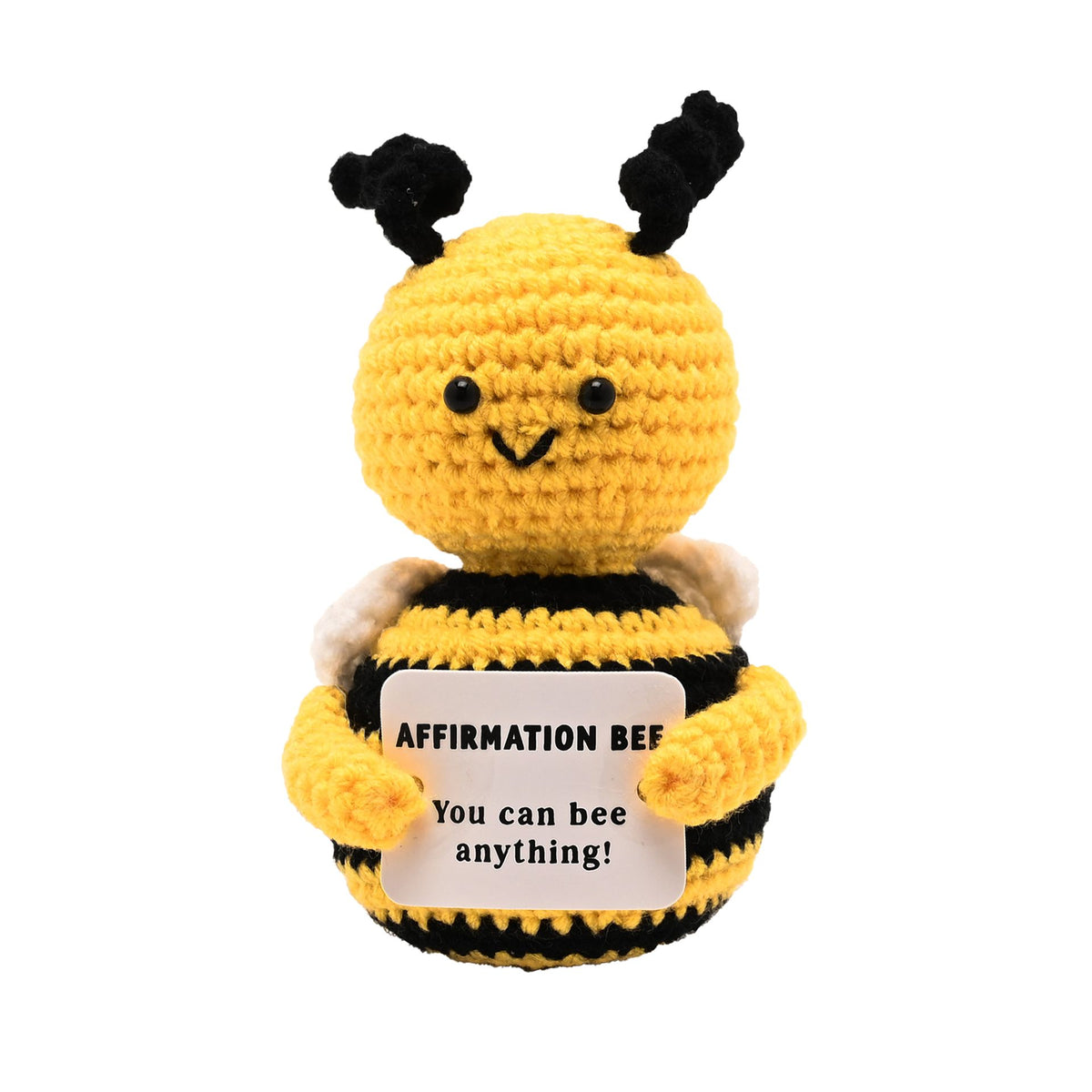 A yellow and black crocheted bee plush toy holding a white sign that reads 'AFFIRMATION BEE You can bee anything!' on a plain white background.