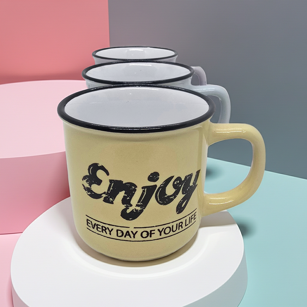 Yellow mug with 'Enjoy every day of your life' text on a colorful background