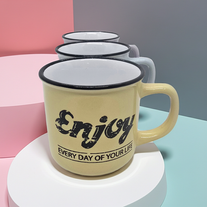 Yellow mug with 'Enjoy every day of your life' text on a colorful background