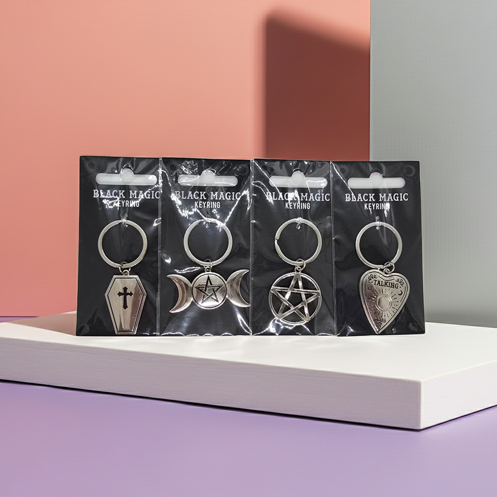 Four metal keychains with black Magic branding Keyrings available include a Coffin, Planchette, Pentagram & Pentagram with Moons