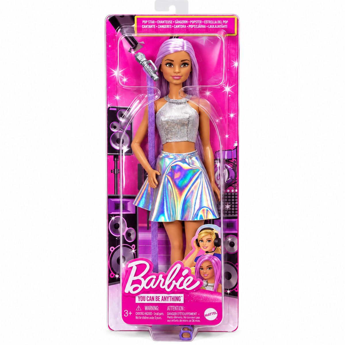 Barbie fashion doll in retail packaging, featuring a doll with pink hair wearing a silver crop top and holographic skirt, posed with a microphone in front of a speaker graphic on a pink cardback.