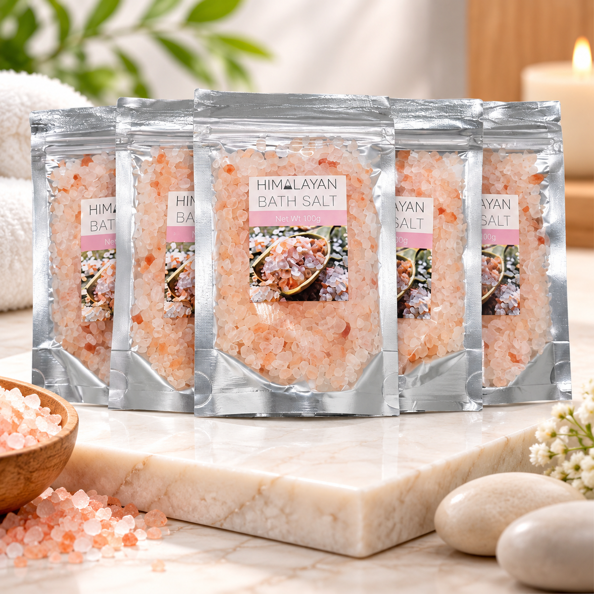 Five stand-up pouches of Himalayan bath salt arranged in a fan shape on a plain white background. The silver resealable bags show pink salt crystals through the packaging and a front label reading 'HIMALAYAN BATH SALT' with a small product photo.