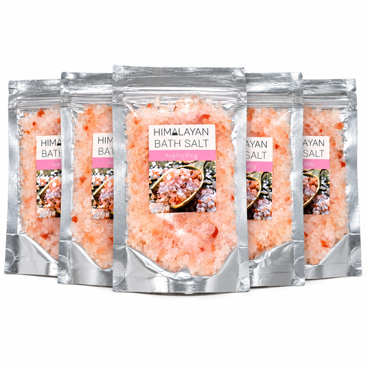 Five stand-up pouches of Himalayan bath salt arranged in a fan shape on a plain white background. The silver resealable bags show pink salt crystals through the packaging and a front label reading 'HIMALAYAN BATH SALT' with a small product photo.
