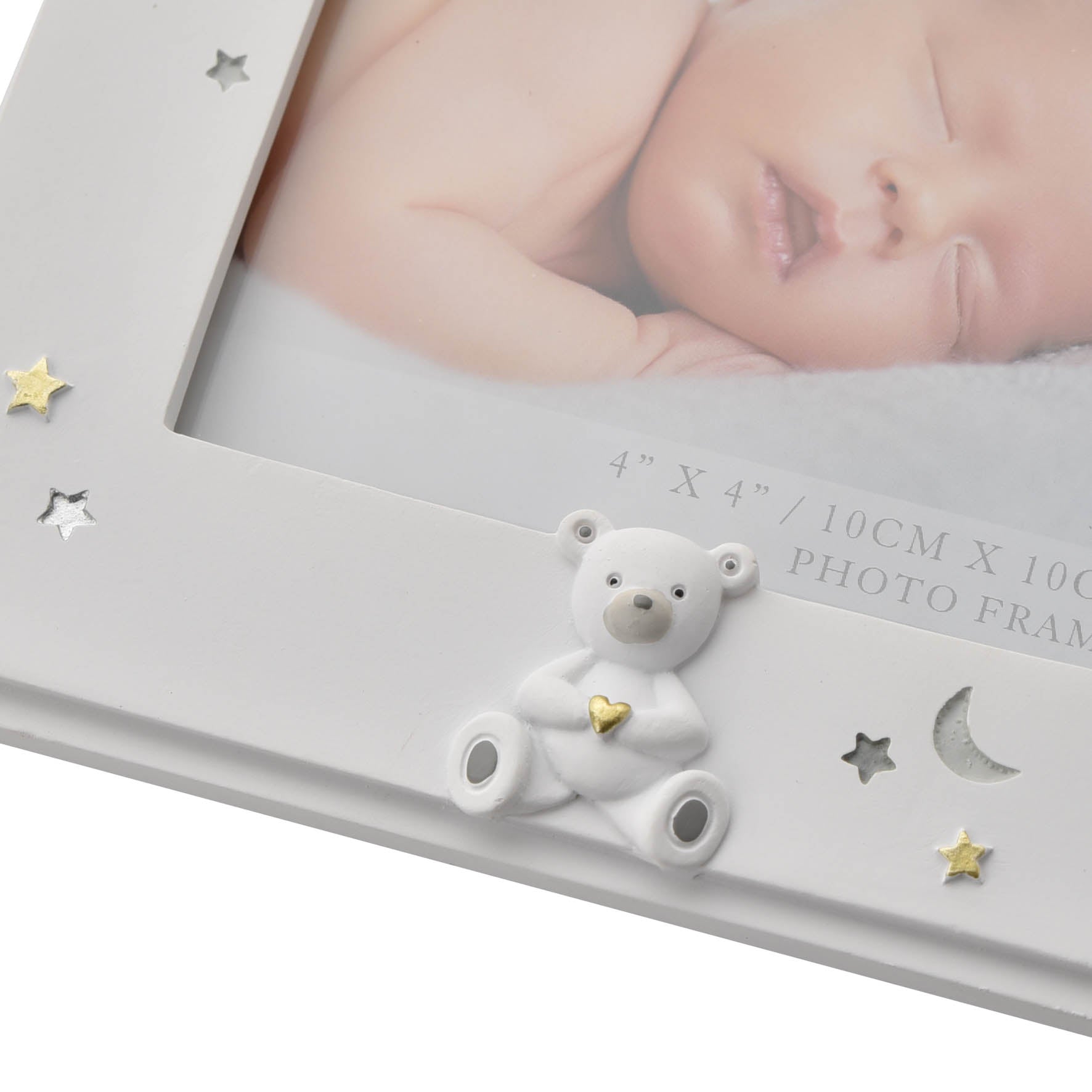 White photo frame with a white teddy bear ornament with engraved stars and moon
