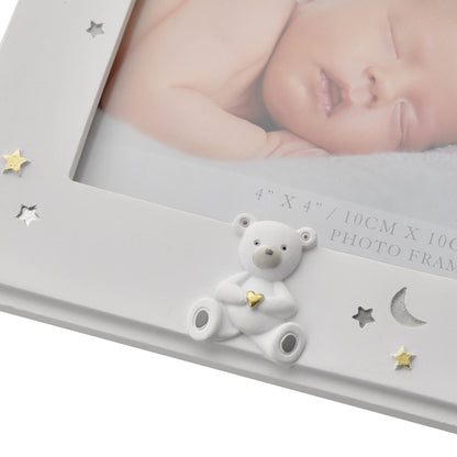 Gray photo frame with a teddy bear decoration and a baby photo inside