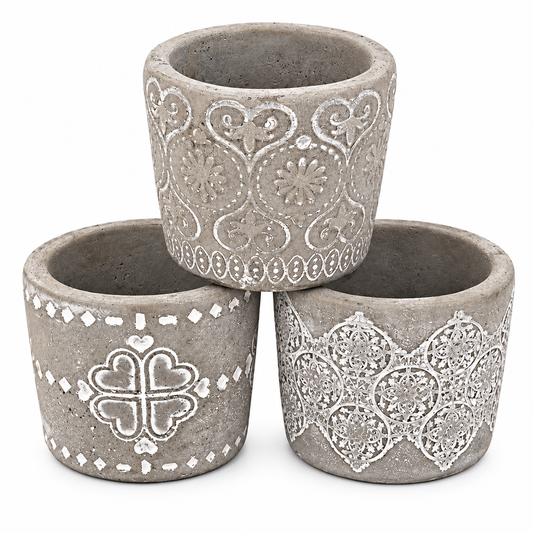 Three small concrete planters with white decorative patterns, arranged in a pyramid stack on a white background.