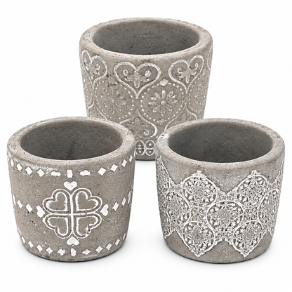 Three gray concrete-style candle holders with white decorative patterns, arranged on a white background.