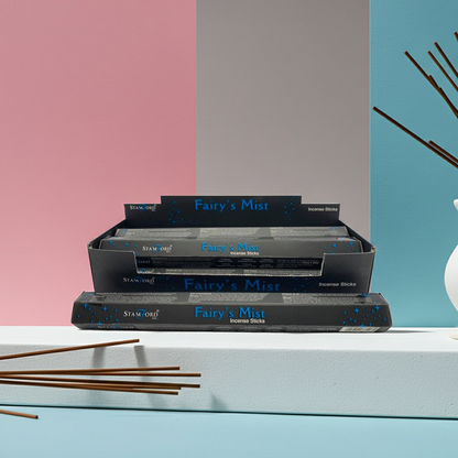Stack of 'Fairy's Mist' incense sticks packaging with sticks in front on a colorful background