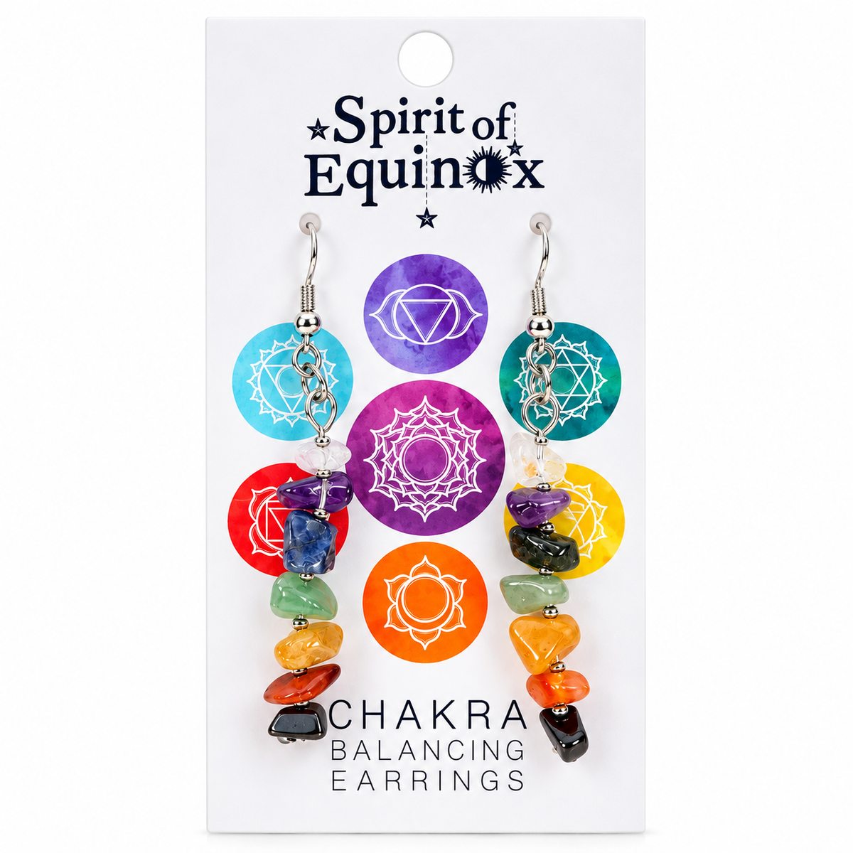 Spirit of Equinox Chakra Balancing Earrings on a white display card. The earrings feature silver-toned hooks, small silver beads, and circular chakra symbols in light blue, purple, red, orange, green, yellow, and teal, with dangling polished gemstone beads in matching colors.