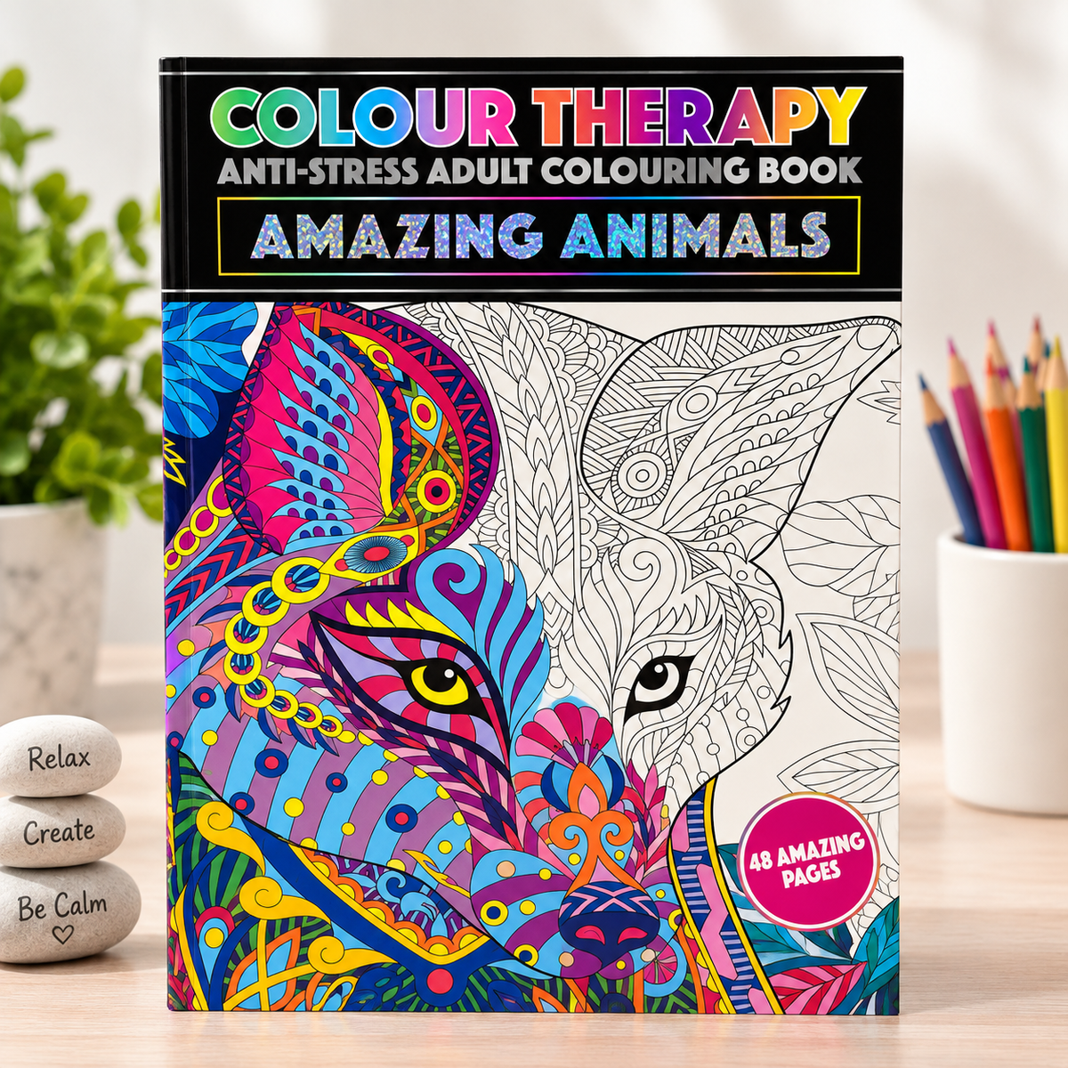 A boxed adult coloring book titled "Colour Therapy Anti-Stress Adult Colouring Book: Amazing Animals" stands on a tabletop. The front cover shows a stylized animal face split into colorful filled artwork on the left and black line art on the right, with a pink badge reading "48 Amazing Pages.