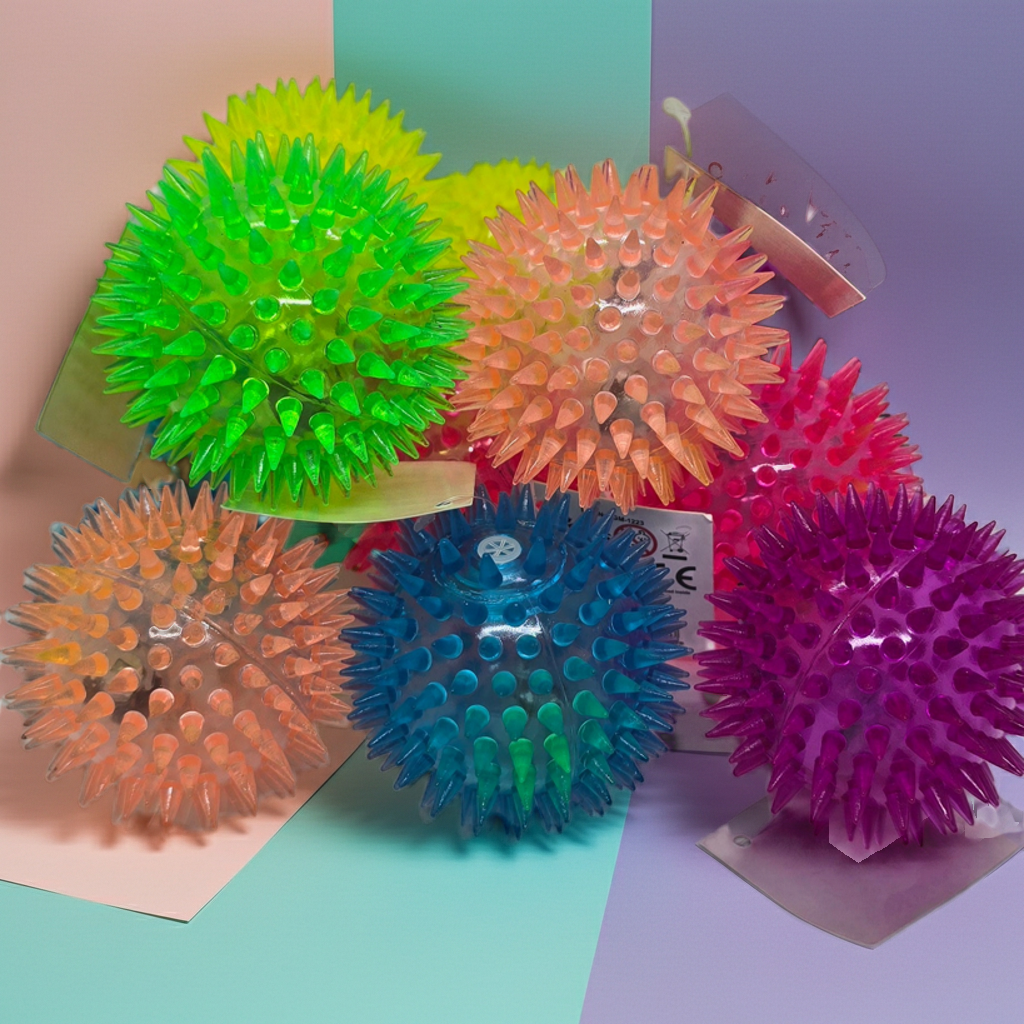 Colourful spiky balls that bounce and light up on a multicoloured background