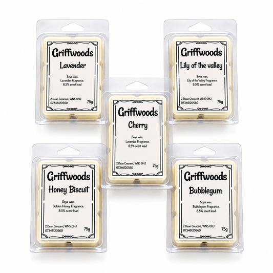 Five Griffwoods wax melts in clear plastic hangers arranged in a 2x2 grid with one centered in front. The labels show different scents: Lavender, Lily of the valley, Cherry, Honey Biscuit, and Bubblegum.