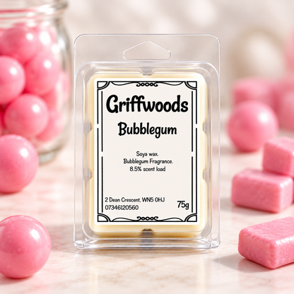 A packaged wax melt labeled 'Griffwoods Bubblegum' in a clear plastic clamshell package, centered on a light marble surface with pink bubblegum candies and pink spheres around it.