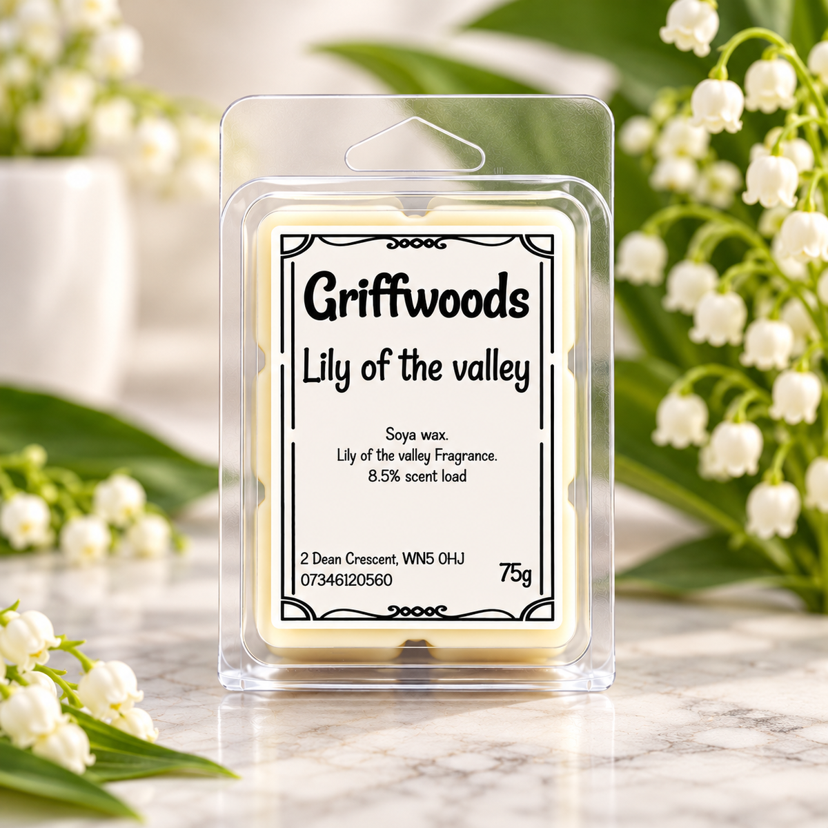 Griffwoods 'Lily of the valley' soya wax melts in a clear plastic clamshell package, displayed on a marble surface with white lily of the valley flowers in the background.