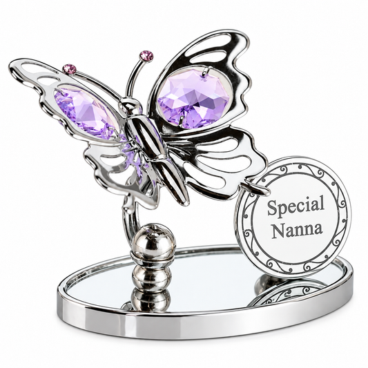 A silver butterfly figurine with faceted purple crystal wings, mounted on a mirrored oval base and holding a round white tag that reads 'Special Nanna'.