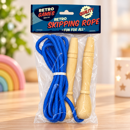 A packaged blue skipping rope with two light wood handles, sealed in a clear plastic bag with a blue header card that reads 'Retro Skipping Rope' and 'Retro Games'. The product is photographed on a wooden table with a softly blurred indoor background.
