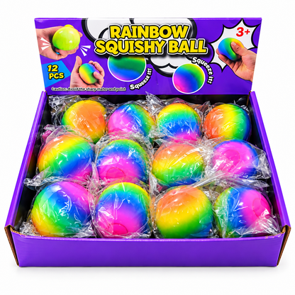 A purple retail display box containing 12 rainbow-colored squishy balls, each individually wrapped in clear plastic. The box lid features a purple background with the text 'RAINBOW SQUISHY BALL' and illustrations of hands squeezing the balls.