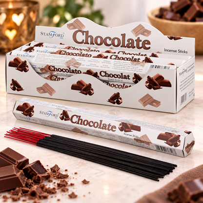A display box and individual tube of Stamford Chocolate Incense Sticks, with black incense sticks and red tips arranged on a marble surface with chocolate pieces and a blurred background.