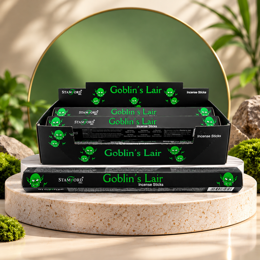 A stack of Stamford 'Goblin's Lair' incense sticks in black packaging with bright green text and skull graphics, displayed on a round stone pedestal with decorative plants and a green circular backdrop.
